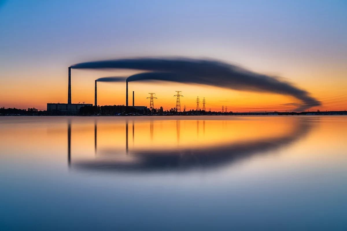 Industrial power station stacks at sunset